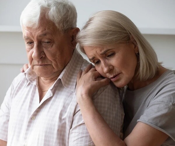 woman hugging older man