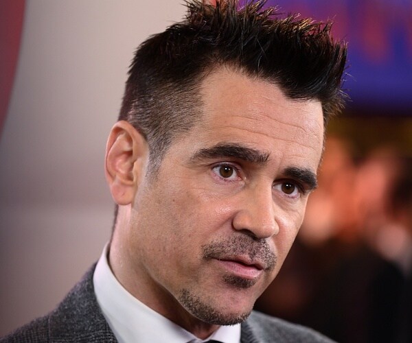colin farrell stands on red carpet