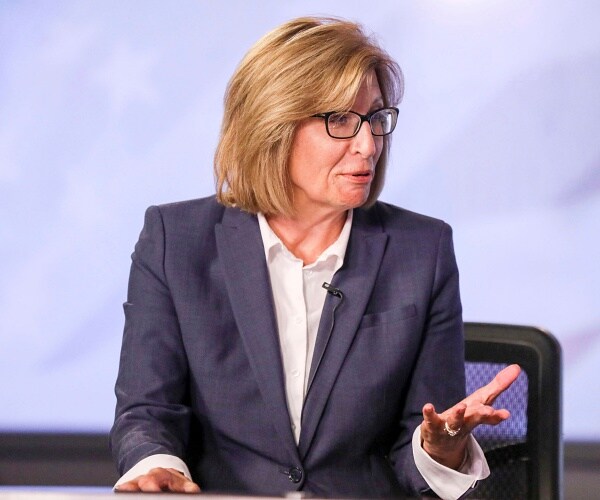 rita hart sits onstage at debate