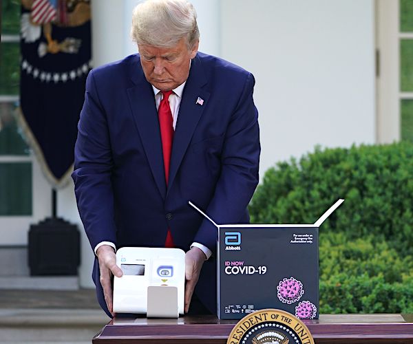 president donald trump shows off the new quick tester at a task force briefing
