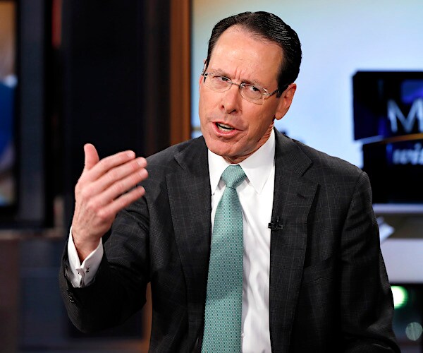 Randall Stephenson gestures during a televised interview