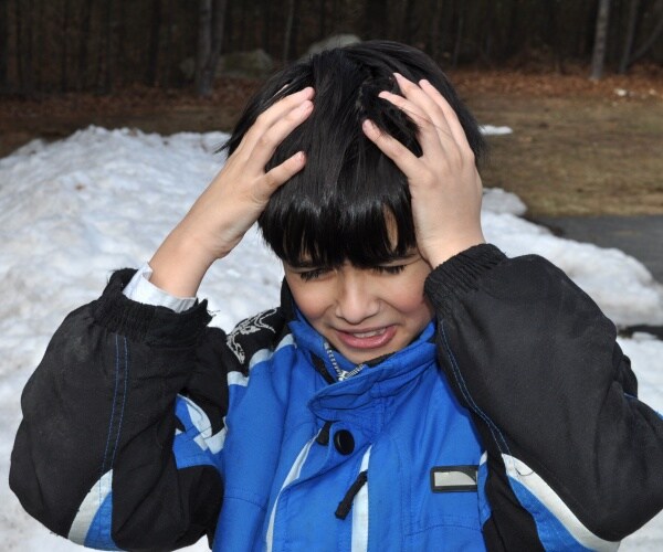 kid with hands on his head