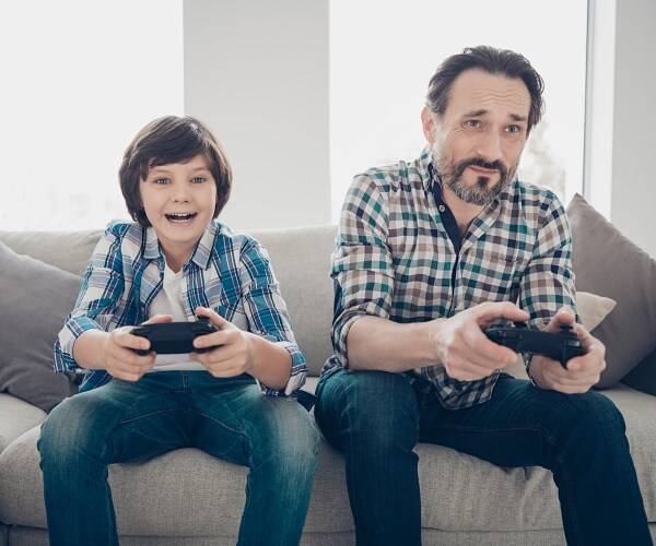 father and son play video game