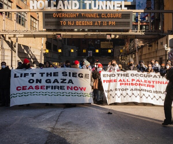 palestine supporters with signs and flags block holland tunnel