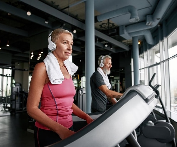 man and woman working out in gym