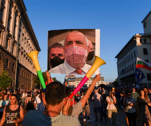 protestors in the street carrying signs