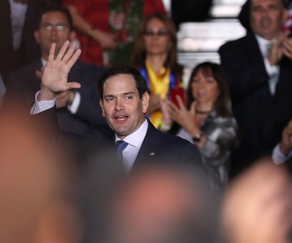 sen. marco rubio waves to a crowd at a rally