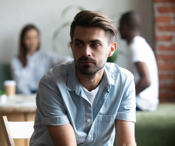 a young man sits by himself