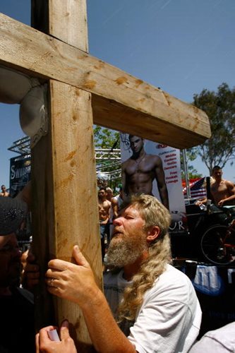 Religious Protester Holds Large Wooden Cross