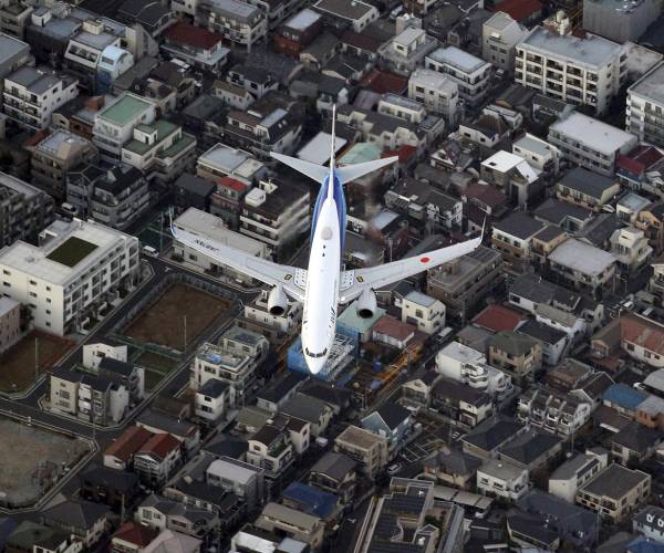 a jet flying over a city