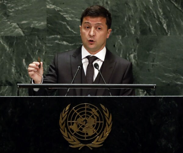 ukrainian president volodymyr zelenskiy standing at a podium