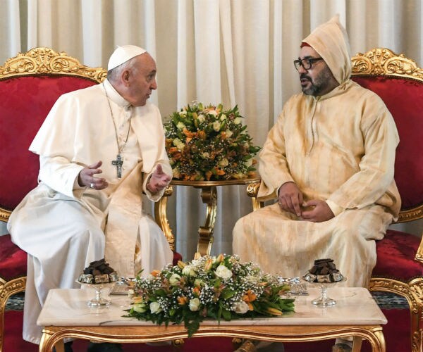 pope francis and king mohammed seated and talking