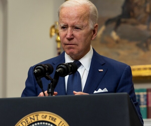Joe Biden delivers speaks into a microphone