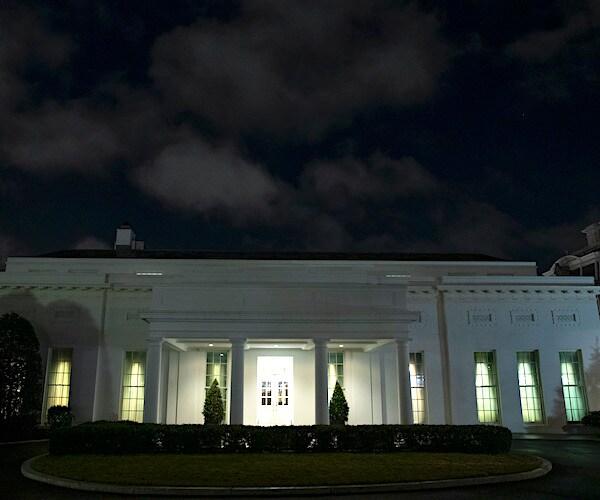 the white house's west wing has its lights on in the dark of night