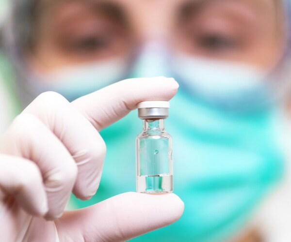 a doctor holding a vaccine