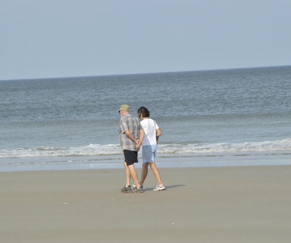 older couple strolling on beach