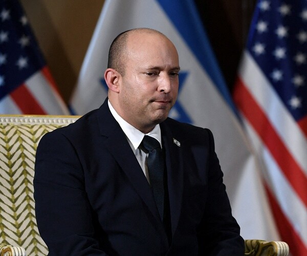 nafali bennett sits in chair