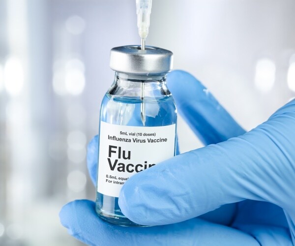 vial labeled Flu Vaccine and syringe