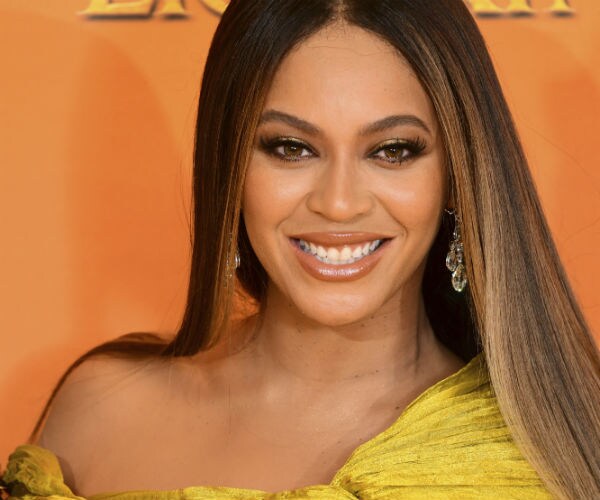 singer beyonce is shown in a gold gown