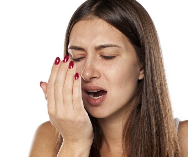 woman checking herself for bad breath