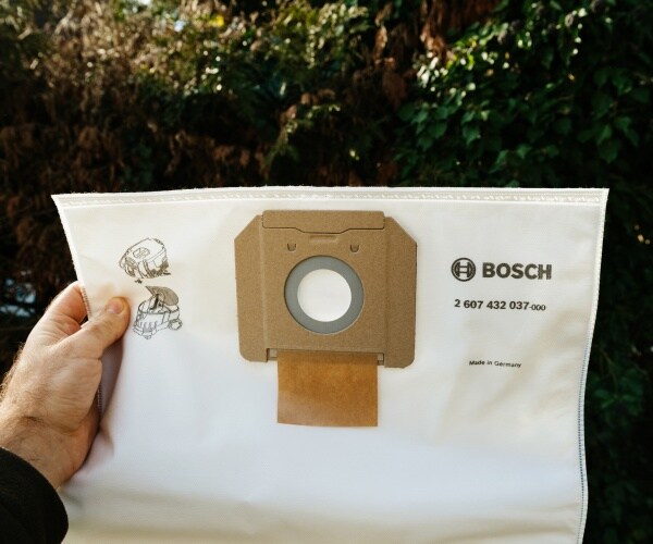 man holds a bosch vacuum cleaner bag