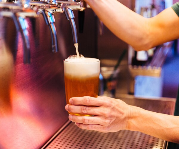 pouring a beer from a tap