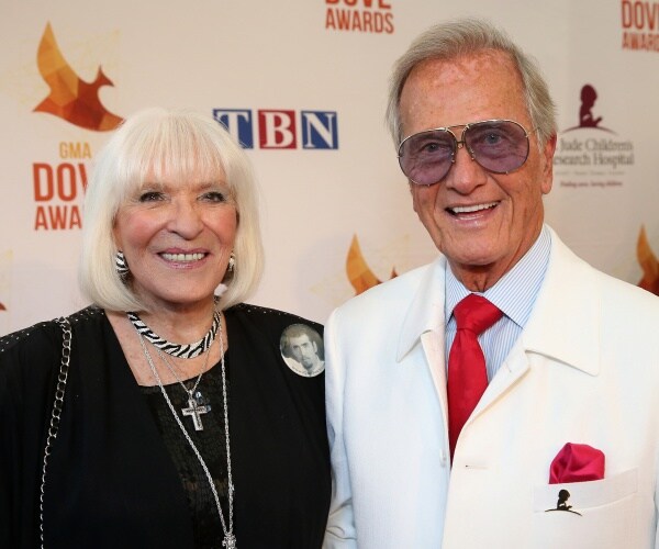 pat boone in a white suit and shirley in a black dress