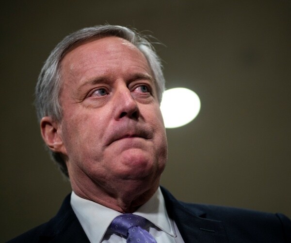 meadows wearing a suit looking up