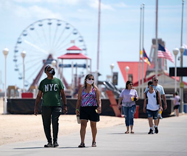 tourists visit ocean city maryland with social distancing and face masks