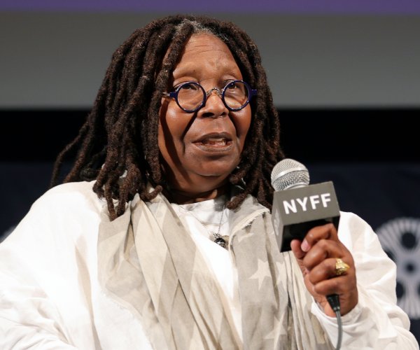 whoopi goldberg speaking at a news conference