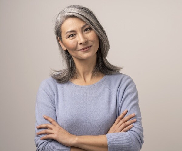 pretty woman with nice gray hair cut looking at camera