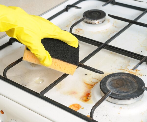 cleaning a dirty stove