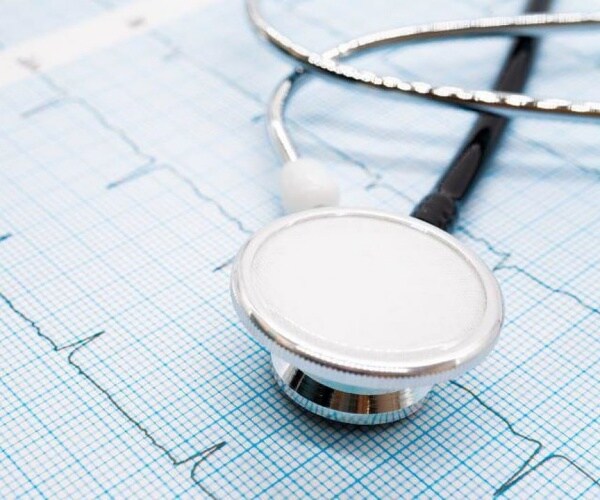 stethoscope on print out of a person's heart rhythm