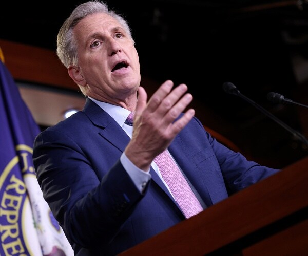 kevin mccarthy talks into mic at press conference