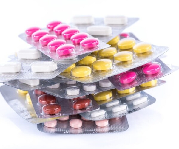 antibiotic pills in blister packs piled up on top of each other