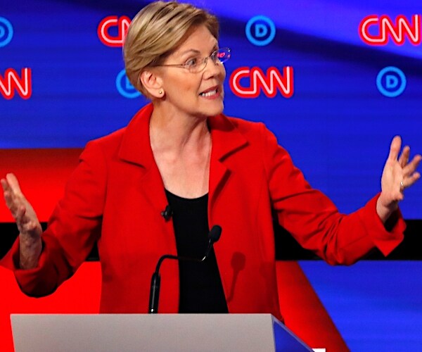 elizabeth warren throws up both hands during a democratic presidential primary