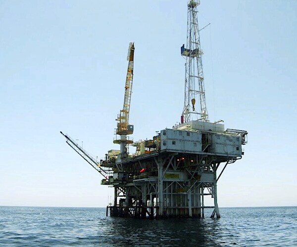 an offshore oil rig out on the open ocean
