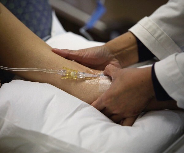 a student in depaul university's chronic illness initiative program who suffers from ms takes an infusion treatment.