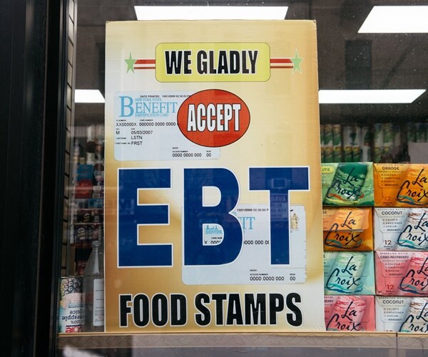 a sign on a grocery store says they accepts food stamps