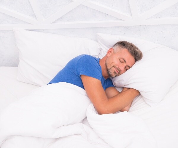 man sleeping in bed