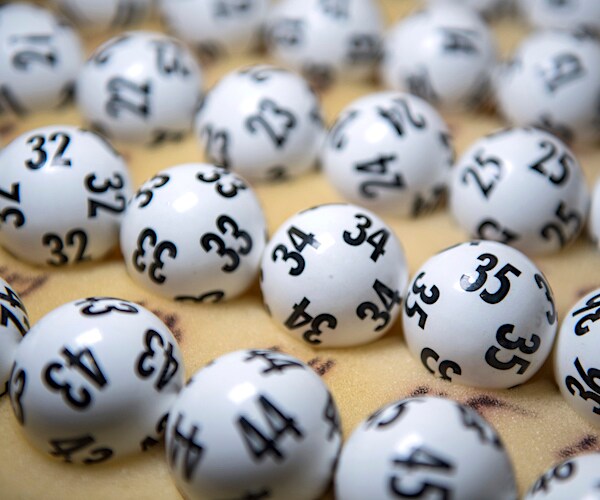 a collection of lottery balls are laid out about a foam surface