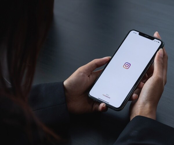 Woman's hand holding iPhone 
