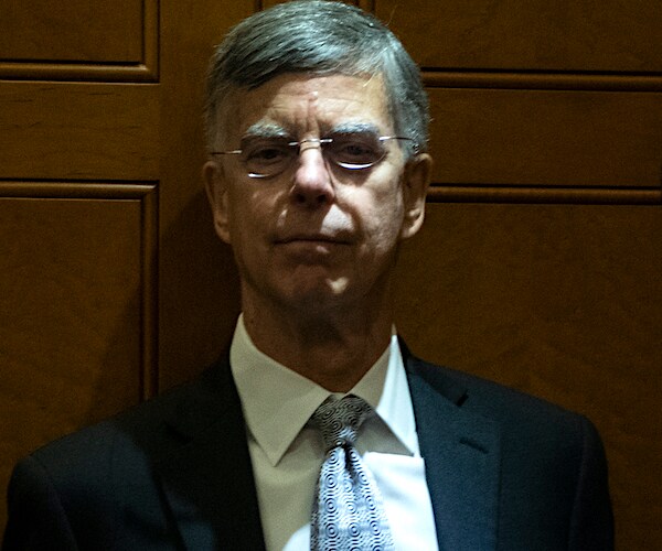 bill taylor stands at the back of an elevated in short light