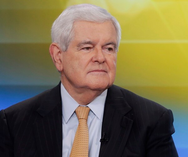 newt gingrich sits on a set 