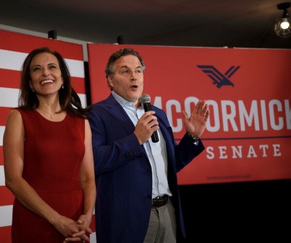 dave mccormick and his wife dina powell smile