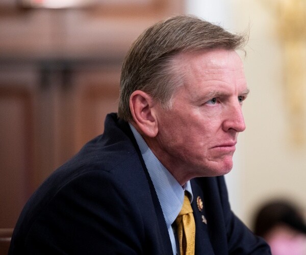 gosar in a suit, blue shirt, and yellow tie