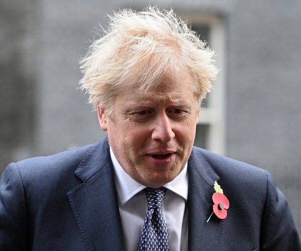 boris johnson walks down street