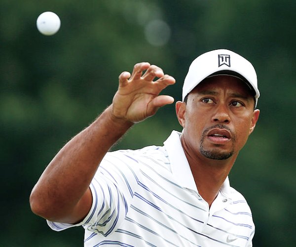 tiger woods catches a ball