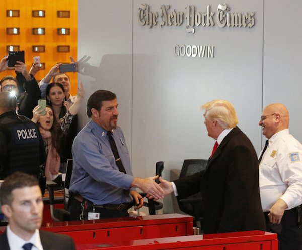 trump shakes the hands of someone upon his visit to the new york times office shortly after his election