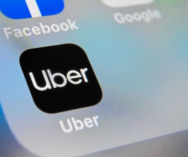 logo of uber app displayed on a tablet screen